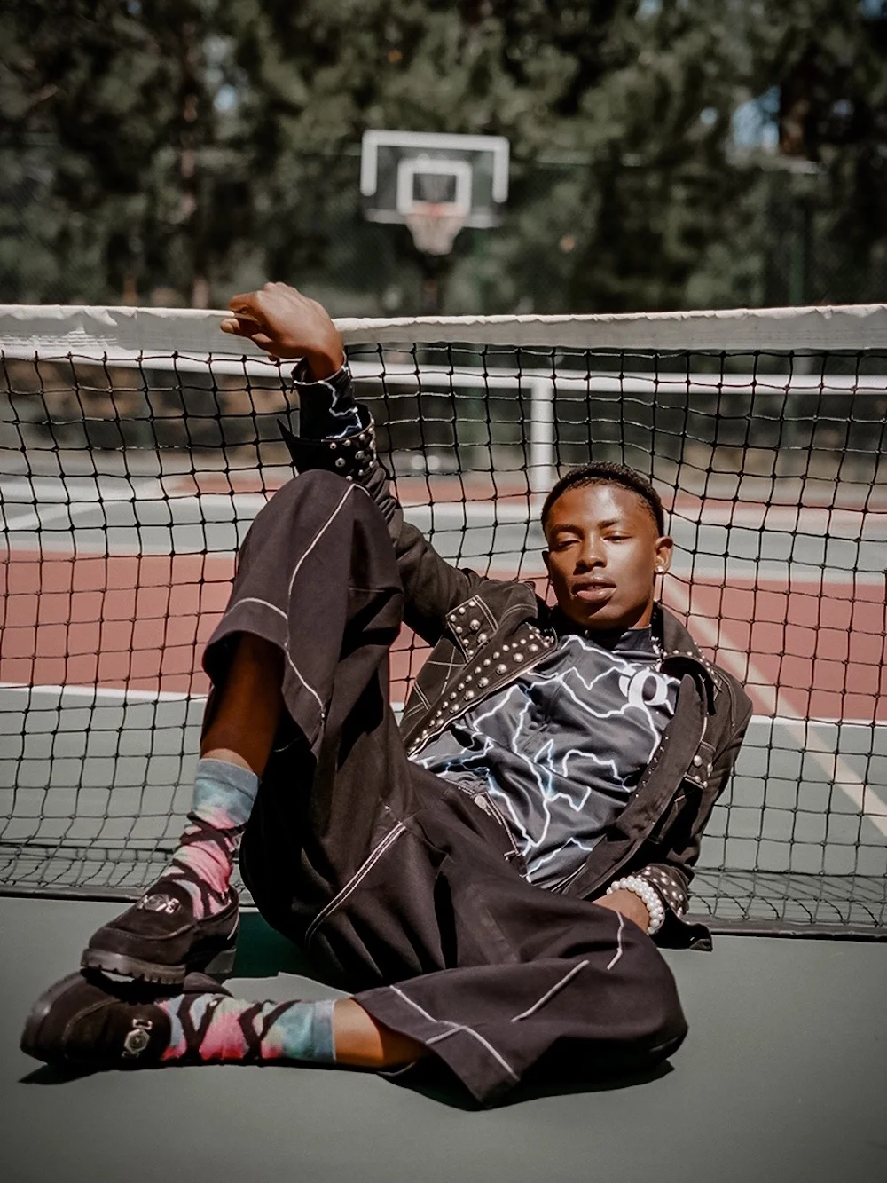 Model sitting on a tennis court