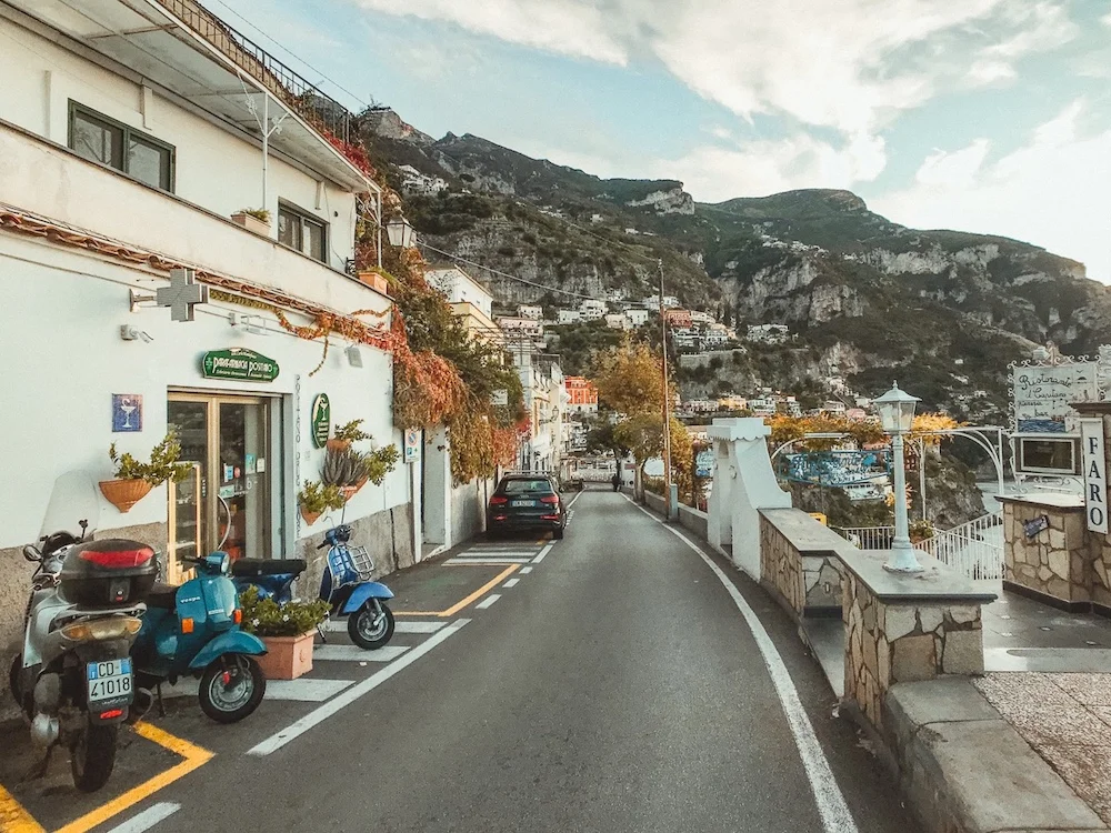 Scooters parked on an Italian coastal village street